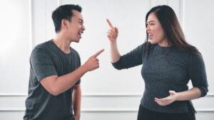 Two colleagues have a conflict and argument in the workplace.